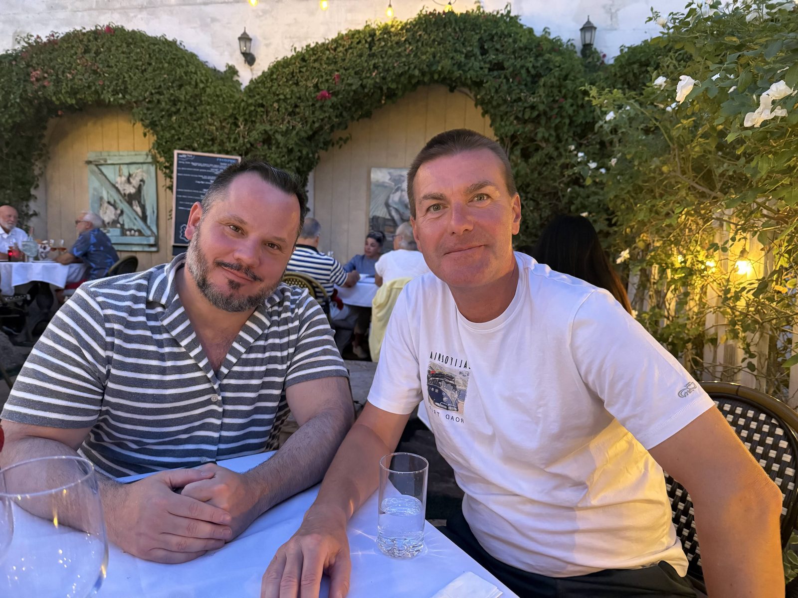 Nicholas and Philip at dinner on a garden patio in Palm Springs