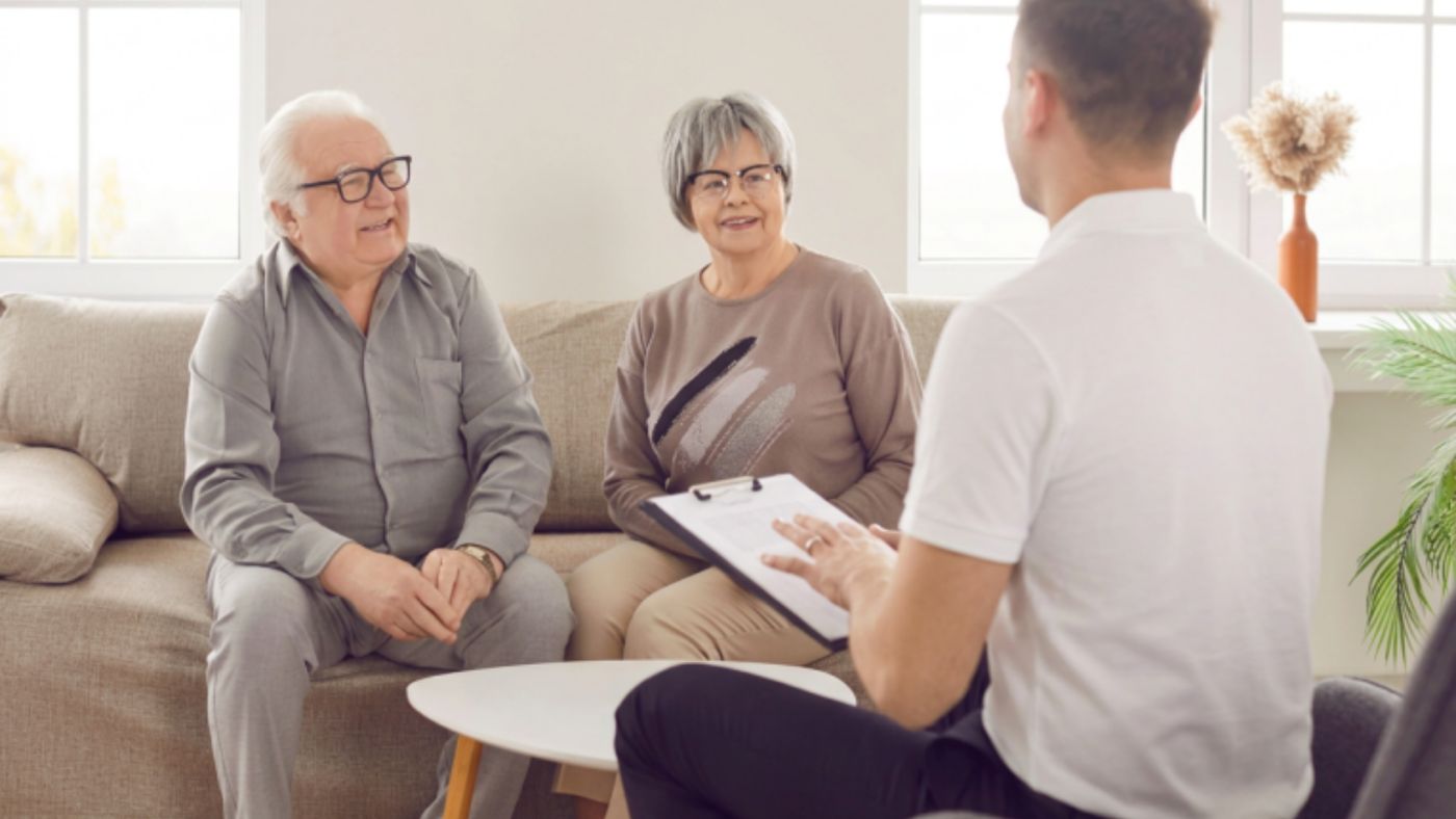 An older couple meeting with a Cliffrose partner at home